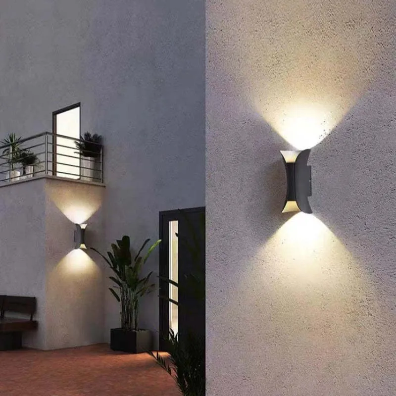 Modern outdoor LED wall light with curved design directing light up and down