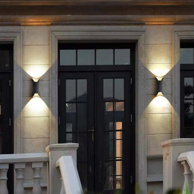 Modern outdoor LED wall light with curved design directing light up and down