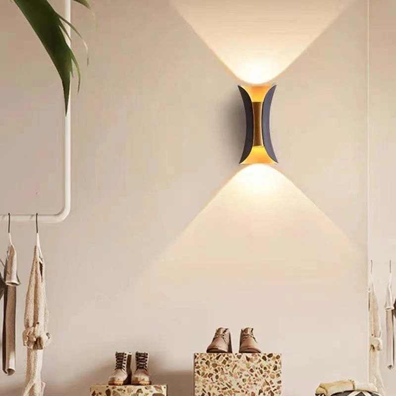 Modern outdoor LED wall light with curved design directing light up and down