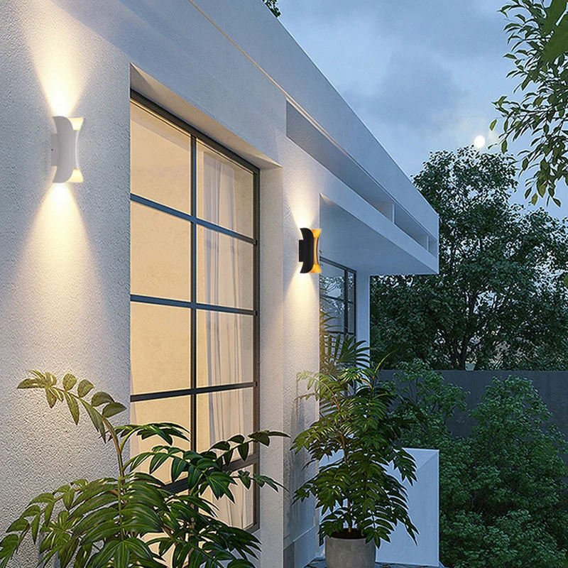 Modern outdoor LED wall light with curved design directing light up and down