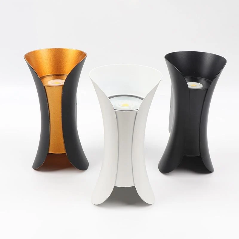 Modern outdoor LED wall light with curved design directing light up and down