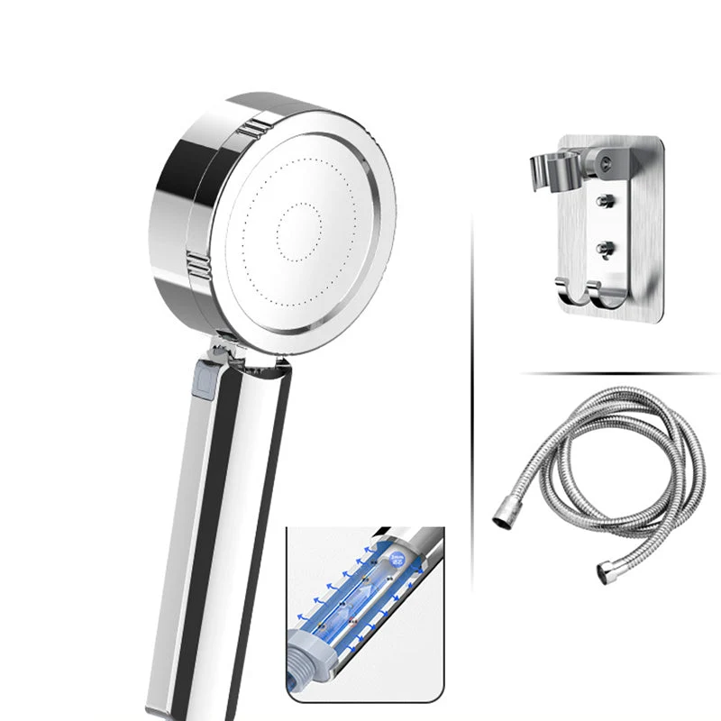 Adjustable handheld shower head with self-cleaning nozzles
