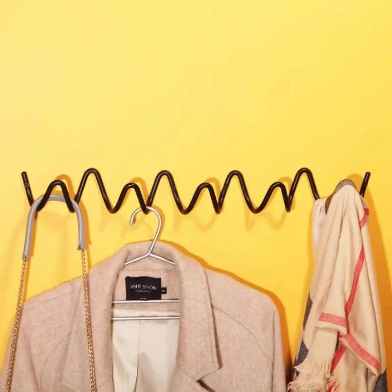 Space-saving wall hanger with multiple hooks wave