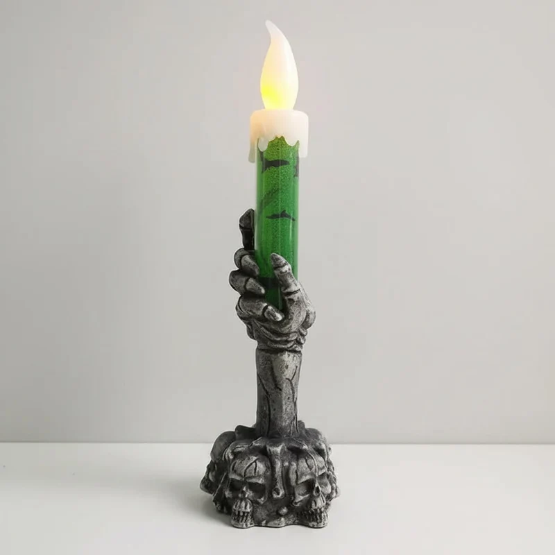 Decorative Halloween LED candle in a skeleton's hand with bats and skulls