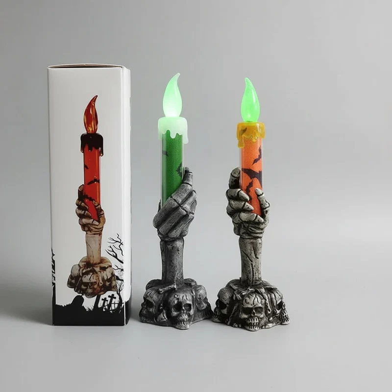 Decorative Halloween LED candle in a skeleton's hand with bats and skulls