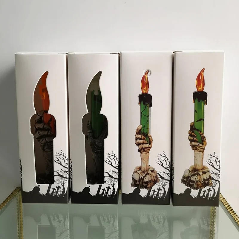 Decorative Halloween LED candle in a skeleton's hand with bats and skulls